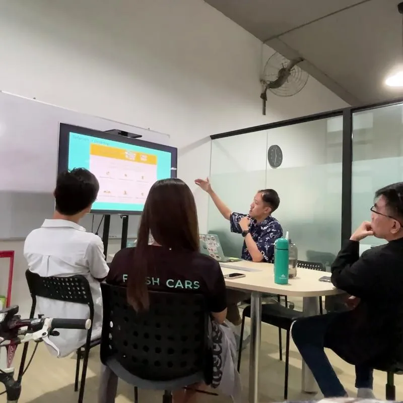 Nelton presenting the Fresh Cars website design during a stakeholder review with the company team
